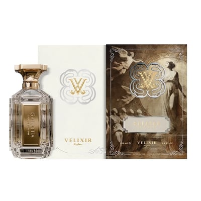 Velixir Galatea 100ml EDP — A clear glass perfume bottle with a gold cap and label, placed next to its ornate, cream and gold box featuring a classical painting and the brand's 'V' logo. | Velixir Galatea 100ml EDP — Botol minyak wangi kaca jernih dengan penutup dan label emas, diletakkan di sebelah kotak berhiasnya