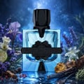 French Avenue Aromatix Magnetiq by French Avenue 100ml — A blue glass perfume bottle with a black cap, surrounded by lavender, iris flowers, lime, vanilla pods, and amber stones.