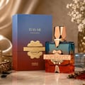 French Avenue Aromatix Teas Me — A gradient blue and red box stands next to a clear glass perfume bottle with blue and orange liquid, featuring a gold cap and emblem.