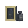 Lattafa Bade'e Al Oud Black Exposed — Black perfume bottle with ornate gold detailing, partially obscured by a soft purple flower petal.