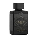 Lattafa Bade'e Al Oud Black Exposed Lattafa 100ml — Black perfume bottle with ornate detailing, surrounded by purple irises and amber-colored liquid droplets.