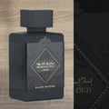 Lattafa Bade'e Al Oud Black Exposed Lattafa 100ml — Black perfume bottle and its gold-trimmed display box, both featuring diamond-shaped emblems and Arabic text.