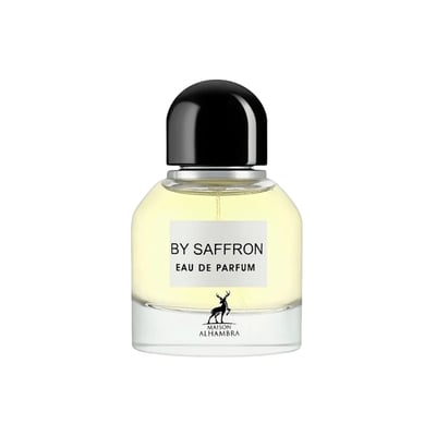 Maison Alhambra By Saffron Eau de Parfum — A clear glass perfume bottle with a black cap, containing pale yellow liquid. A white label reads 'BY SAFFRON EAU DE PARFUM' and features a deer silhouette above 'MAISON ALHAMBRA'.
