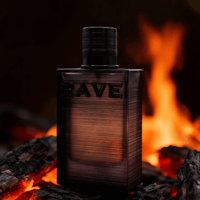 Rave Nuit Parfaite by Rave 100ml EDP — A dark glass perfume bottle with 'RAVE' embossed on the front, placed on burning charcoal with flames in the background.