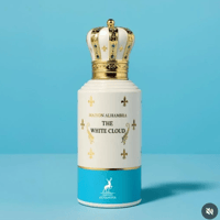 Maison Alhambra The White Cloud — White perfume bottle with a gold and white crown-shaped cap, decorated with gold fleur-de-lis and blue accents, set against a bright blue background.