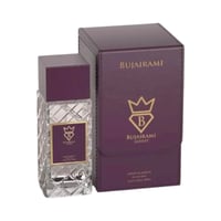 Bujairami Amber Eclipse by Bujairami 100ml Extrait — Botol minyak wangi kaca jernih berpetak, bertudung ungu gelap, bersebelahan kotak persembahannya yang sepadan berwarna ungu gelap dengan tulisan dan logo emas.