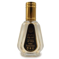 Ard Al Zaafaran Badee Al Oud Eau De Parfum 50ml — A clear glass perfume bottle with a faceted design and a gold cap, featuring a black label with Arabic and English text. | Ard Al Zaafaran Badee Al Oud Eau De Parfum 50ml — Botol minyak wangi kaca jernih dengan reka bentuk berfaset dan penutup emas, menampilkan label