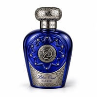 Lattafa Blue Oud Elixir — Botol minyak wangi biru terang dengan perincian perak yang rumit dan penutup perak berhias, berlatar belakang putih.