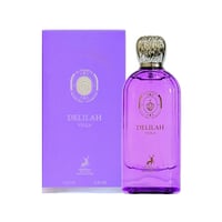 Maison Alhambra Delilah Viola 100ml — A purple glass perfume bottle with a gold cap sits next to its matching purple box, both featuring gold text and a deer emblem. | Maison Alhambra Delilah Viola 100ml — Botol kaca ungu dengan penutup emas duduk bersebelahan dengan kotak ungu yang sepadan, kedua-duanya menampilkan