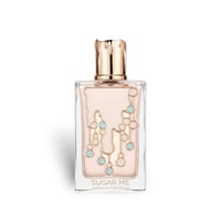 Maison Alhambra Sugar Me Marshmallow Dream — Rectangular glass perfume bottle with a gold, textured cap. The bottle contains pale pink liquid and features a decorative pattern of gold lines and light blue circles.