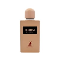 Maison Alhambra Floral Bloom — A light beige perfume bottle with a peach cap, featuring a black label with white text 'FLORAL BLOOM' and a red deer logo with 'MAISON ALHAMBRA' text below. | Maison Alhambra Floral Bloom — Botol minyak wangi berwarna beige muda dengan penutup pic, menampilkan label hitam dengan teks