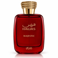 RASASI Hawas Majestic by Rasasi 100ml EDP — Botol minyak wangi kaca merah dengan penutup emas bertekstur, tertulis teks emas Arab dan Inggeris 'Hawas Majestic' di hadapan.