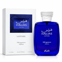 RASASI Hawas Sapphire FB Fragrances Edition oleh Rasasi 100ml EDP — Botol minyak wangi kaca biru dan kotak pembungkusan putih, kedua-duanya memaparkan teks Arab dan Inggeris serta logo jenama.