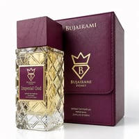 Bujairami Imperial Oud by Bujairami 100ml Extrait — Clear faceted glass perfume bottle with gold liquid, topped with a dark wood cap, next to its matching plum-colored presentation box with gold logo.