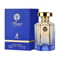Maison Alhambra Kismet Lunar Magic 100ml — A blue box and a clear glass perfume bottle with a gold cap and blue base, featuring intricate patterns on the glass. | Maison Alhambra Kismet Lunar Magic 100ml — Kotak biru dan botol kaca jernih minyak wangi dengan penutup emas dan tapak biru, menampilkan corak rumit pada