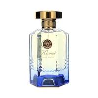Maison Alhambra Kismet Lunar Magic 100ml — Clear glass perfume bottle with a gold cap and a blue faceted base, featuring a circular emblem and "Kismet Lunar Magic" text. | Botol minyak wangi kaca jernih dengan penutup emas dan tapak biru berfaset, menampilkan lambang bulat dan teks "Kismet Lunar Magic".
