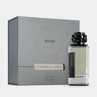 Afnan Lynked Freedom by Afnan Eau De Parfum — Grey gift box with embossed circular pattern and ribbon detail, next to a clear glass perfume bottle with a black chain-link cap and black label.