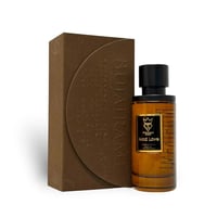 Bujairami Mad Love — Amber glass perfume bottle with a black cap and gold label, next to its textured brown presentation box with embossed floral pattern.