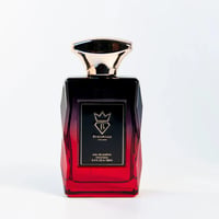 Bujairami Madness by Bujairami 100ml EDP — A faceted glass perfume bottle with a gradient from black to red, featuring a gold cap and a black label with gold text and a crown logo.