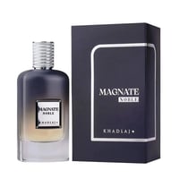 Khadlaj Magnate Noble — A dark grey gradient perfume bottle with a silver textured cap sits next to its matching dark navy box with silver trim. | Khadlaj Magnate Noble — Botol minyak wangi kelabu gradien gelap dengan penutup bertekstur perak terletak di sebelah kotak biru laut gelap yang sepadan dengan trim perak.