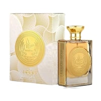 Ard Al Zaafaran Mithqal 100ml — A rectangular glass perfume bottle with a gold cap and a gold circular emblem on the front, next to its matching white and gold patterned box with a similar emblem. | Ard Al Zaafaran Mithqal 100ml — Botol minyak wangi kaca berbentuk segi empat dengan penutup emas dan lambang bulat emas