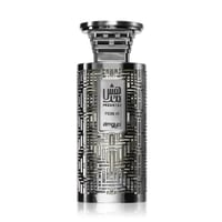 Zimaya Modhesh Noble 100ml by Zimaya — A metallic silver perfume bottle with an intricate geometric pattern and Arabic calligraphy on the label, set against a white background. | Zimaya Modhesh Noble 100ml by Zimaya — Botol minyak wangi perak metalik dengan corak geometri yang rumit dan kaligrafi Arab pada label