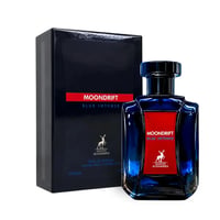Maison Alhambra Moondrift Blue Intense — Botol kaca biru berkilau dengan label merah dan kotak gelap di sebelahnya, latar belakang putih bersih