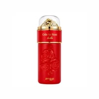 Zimaya Ode to Rose Bella Eau De Parfum — A red perfume bottle with embossed roses and gold accents, topped with a clear dome containing gold-colored decorative elements. | Zimaya Ode to Rose Bella Eau De Parfum — Botol minyak wangi merah dengan bunga ros timbul dan aksen emas, di atasnya terdapat kubah jernih berisi