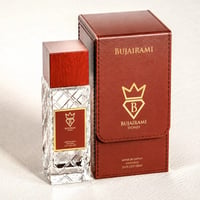 Bujairami Oud Money by Bujairami 100ml Extrait — Clear faceted glass perfume bottle with a red wooden cap and a red label, next to its brown leather presentation box with gold embossed logo.