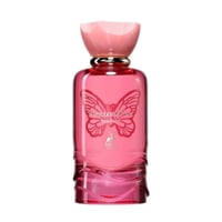 Maison Alhambra Papillon D'Or 100ml by Maison Alhambra — A pink glass perfume bottle with a butterfly design and a pink, petal-shaped cap, set against a white background. | Maison Alhambra Papillon D'Or 100ml by Maison Alhambra — Botol minyak wangi kaca merah jambu dengan rekaan rama-rama dan penutup berbentuk kelopak