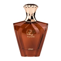 Afnan Turathi Brown – Amber glass perfume bottle with gold cap and Arabic script on a white background.