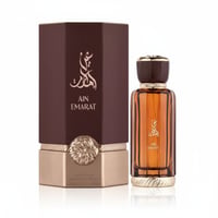 Al Wataniah Ain Emarat — Brown ribbed box with gold eagle emblem next to amber glass perfume bottle with gold accents
