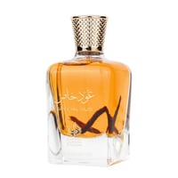 Al Wataniah Special Oud — Amber liquid in a clear glass bottle with a gold textured cap and dark oud wood sticks inside.
