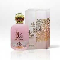 Al Wataniah Tiara Pink – Pink perfume bottle with gold cap and ornate box with gold scrollwork on a white background.