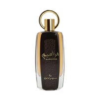 Ard Al Zaafaran Maraseem — Clear glass bottle with dark textured panel, gold accents, and a gold ring cap, isolated on white.
