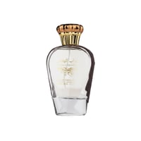 Ard Al Zaafaran Turab Al Dhahab — Clear glass perfume bottle with gold cap and dark brown accents, on a white background.