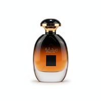 Ard Al Zaafaran Rihanna — Amber gradient glass perfume bottle with black and gold cap, Arabic script and "Rihanna" text