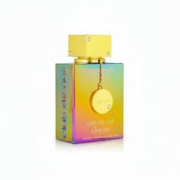 Armaf Club De Nuit Untold — Iridescent bottle with gold cap, gold chain, and circular charm with brand logo.