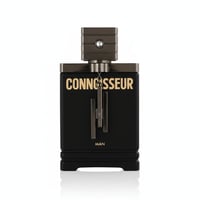 Armaf Connoisseur Man — Black rectangular bottle with gold lettering, metallic cap, and hanging charms on a white background.
