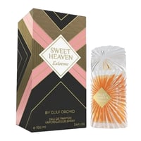 Gulf Orchid Sweet Heaven Extreme — A black, pink, and gold patterned box stands next to a clear glass perfume bottle with an orange liquid and a textured, fan-like cap.