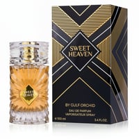 Gulf Orchid Sweet Heaven by Gulf Orchid 100ml EDP Unisex — A clear glass perfume bottle with gold accents and a gold label reading "SWEET HEAVEN", next to its black and gold patterned gift box.
