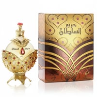 Khadlaj Hareem Al Sultan Gold by Khadlaj 35ml — Ornate gold perfume bottle with red gem accents and a matching decorative box, presented on a white reflective surface.