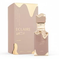Lattafa Eclaire by Lattafa 100ml EDP Women — Perfume bottle and box with gold accents and Arabic text.