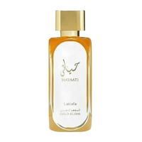 Lattafa Hayaati Gold Elixir — Rectangular glass perfume bottle with golden liquid, white label featuring Arabic script and 'HAYAATI' in gold, 'Lattafa' and 'GOLD ELIXIR' in gold text, topped with a gold cap.