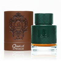 Lattafa Qaaed Al Shabaab by Lattafa 100ml for Men — Green textured perfume bottle with gold accents next to a brown embossed cylindrical box.