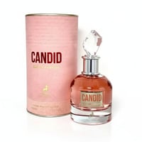 Maison Alhambra Candid Eau de Parfum — Pink textured cylindrical box and a clear glass perfume bottle with rose gold liquid and a faceted crystal cap, set against a white background.