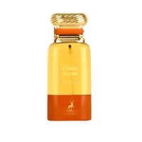Maison Alhambra Coral Blush — A tall, slender perfume bottle with a golden fluted cap and an orange band. The bottle is divided into a translucent yellow upper half and an opaque orange lower half, featuring the brand's deer logo.