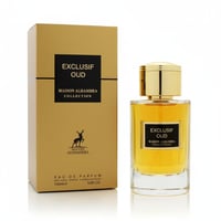 Maison Alhambra Exclusif Oud — Gold box and clear glass perfume bottle with gold cap, filled with amber liquid, isolated on white background.