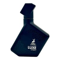 Maison Alhambra Luxe Street – Dark blue angular perfume bottle with geometric pattern and deer logo, isolated on white background.