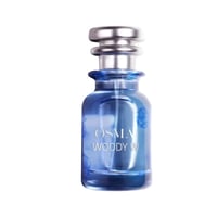 Osma Woody W Bergamot Leather 75ml EDP — Blue glass perfume bottle with silver cap, showing "OSMA WOODY W" text and floral design.